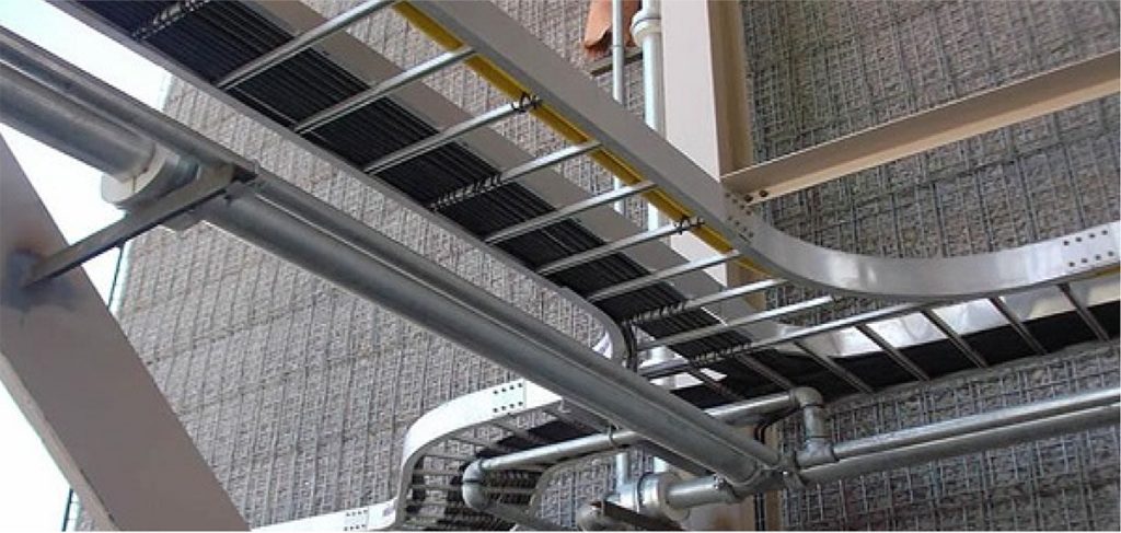 Cable support routes alongside pipework inside an industrial building